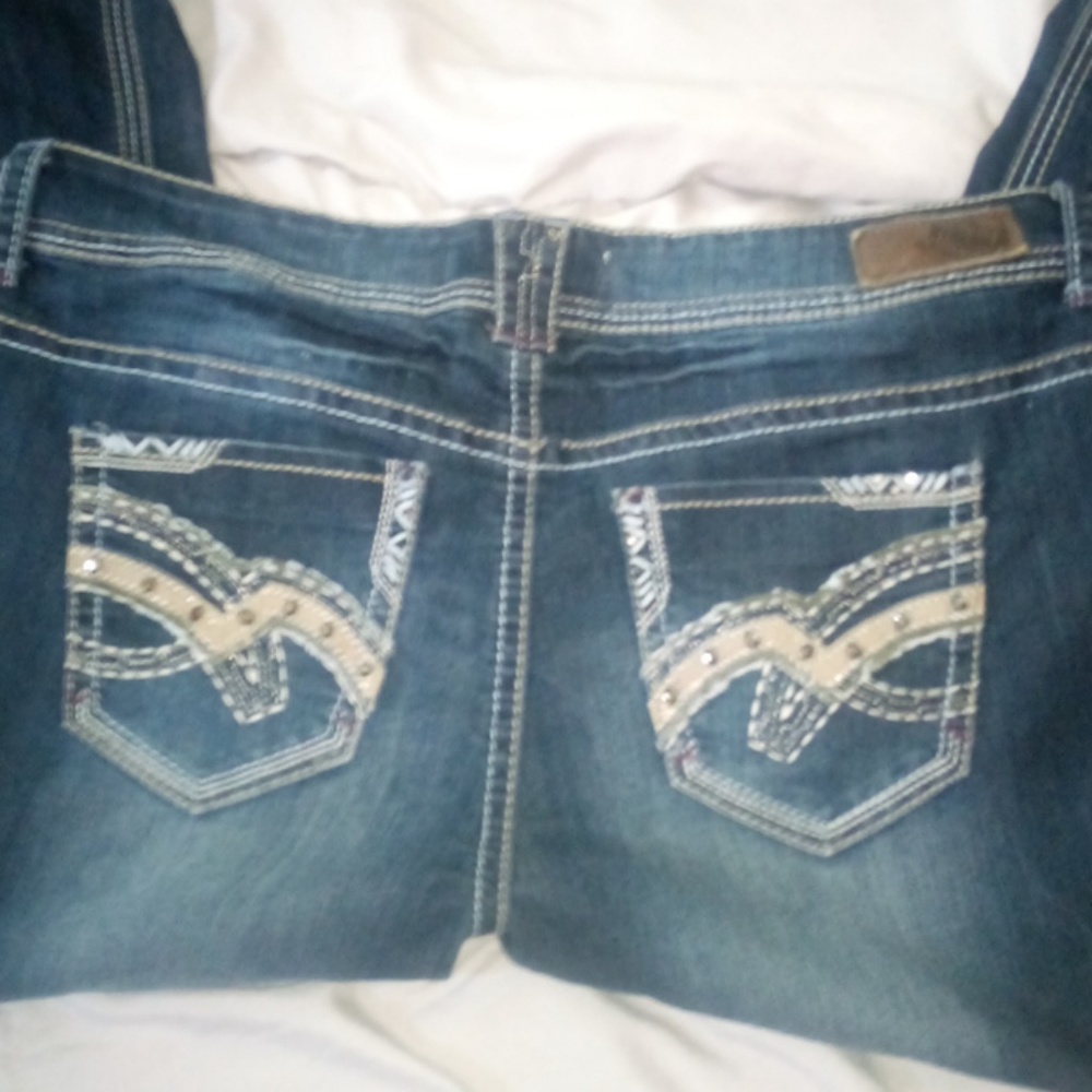 Distressed dark wash hydraulic jeans.